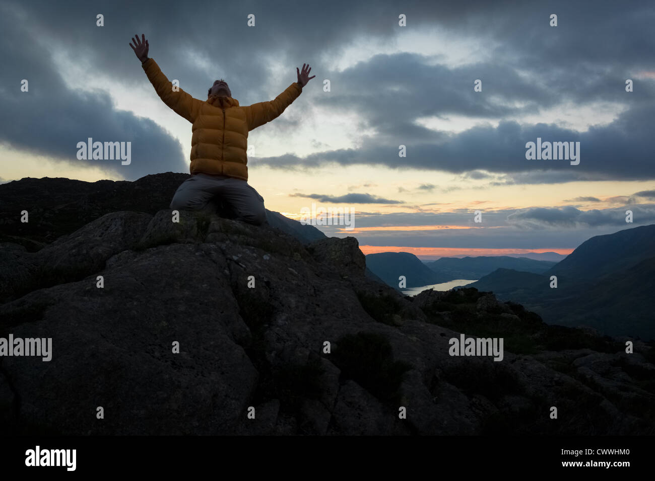 Ein Mann verehren Gott vom Gipfel eines Berges. Stockfoto
