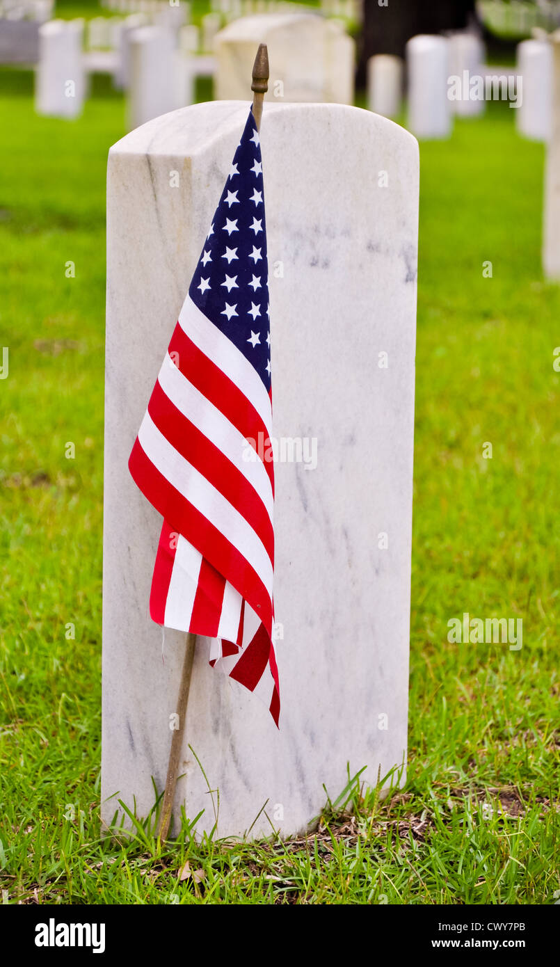 Grabsteine auf dem nationalen Friedhof mit der amerikanischen Flagge Stockfoto