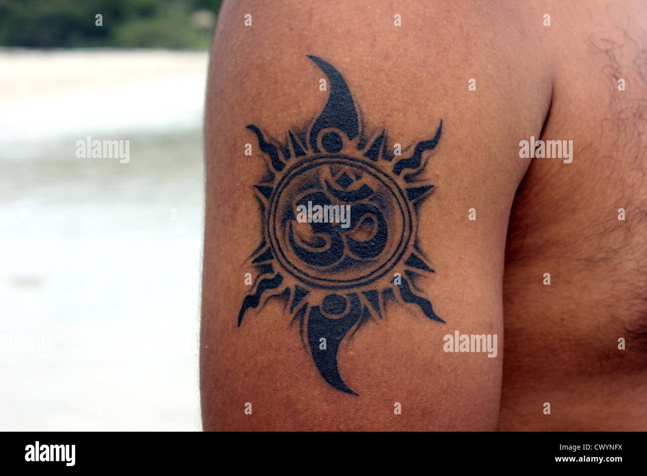 Ein Tattoo von Om mit tribal-Design um ihn herum Stockfoto