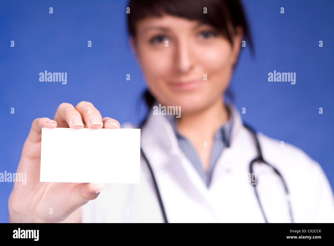 Frauen Arzt hält Leere Visitenkarte. Fokus auf Finger und Karte. Stockfoto