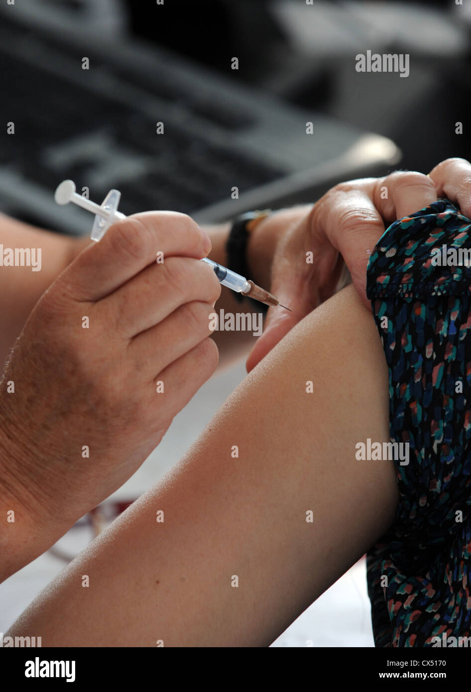 Ein Arzt gibt eine Injektion zu einem Patienten Stockfoto