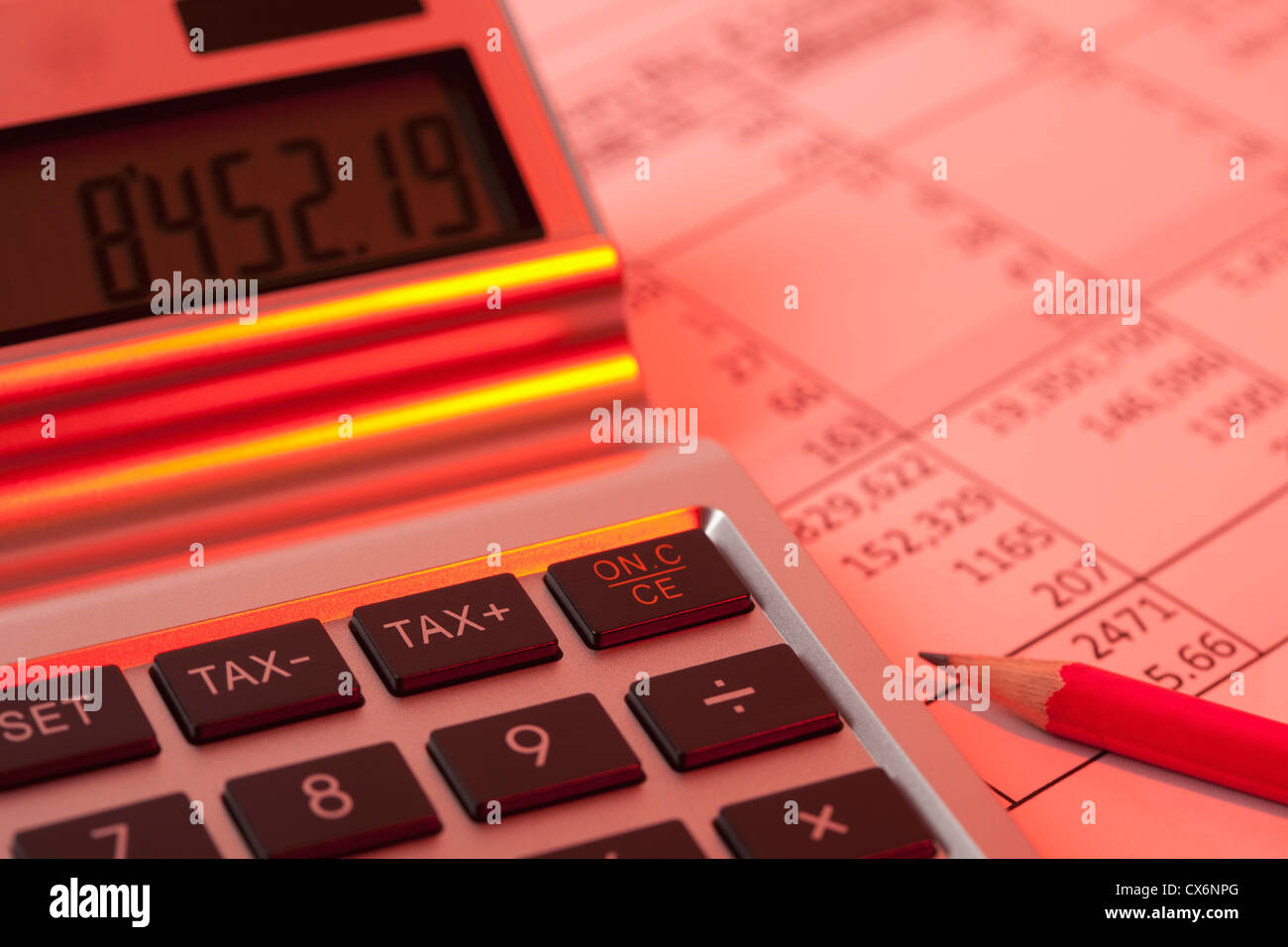 Einen Rechner auf ein Finanzdokument in rotes Licht beleuchtet Stockfoto