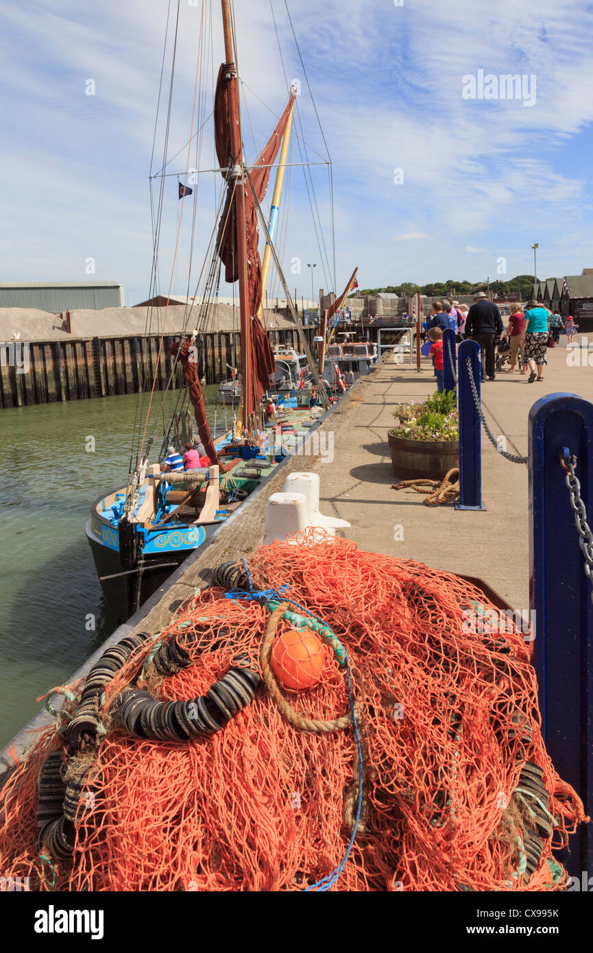 Whitstable Hafen mit bunten Fischernetze am Kai und Segeln Lastkahn Greta in der Themsemündung Whitstable Kent England UK Segeln wird vorbereitet Stockfoto