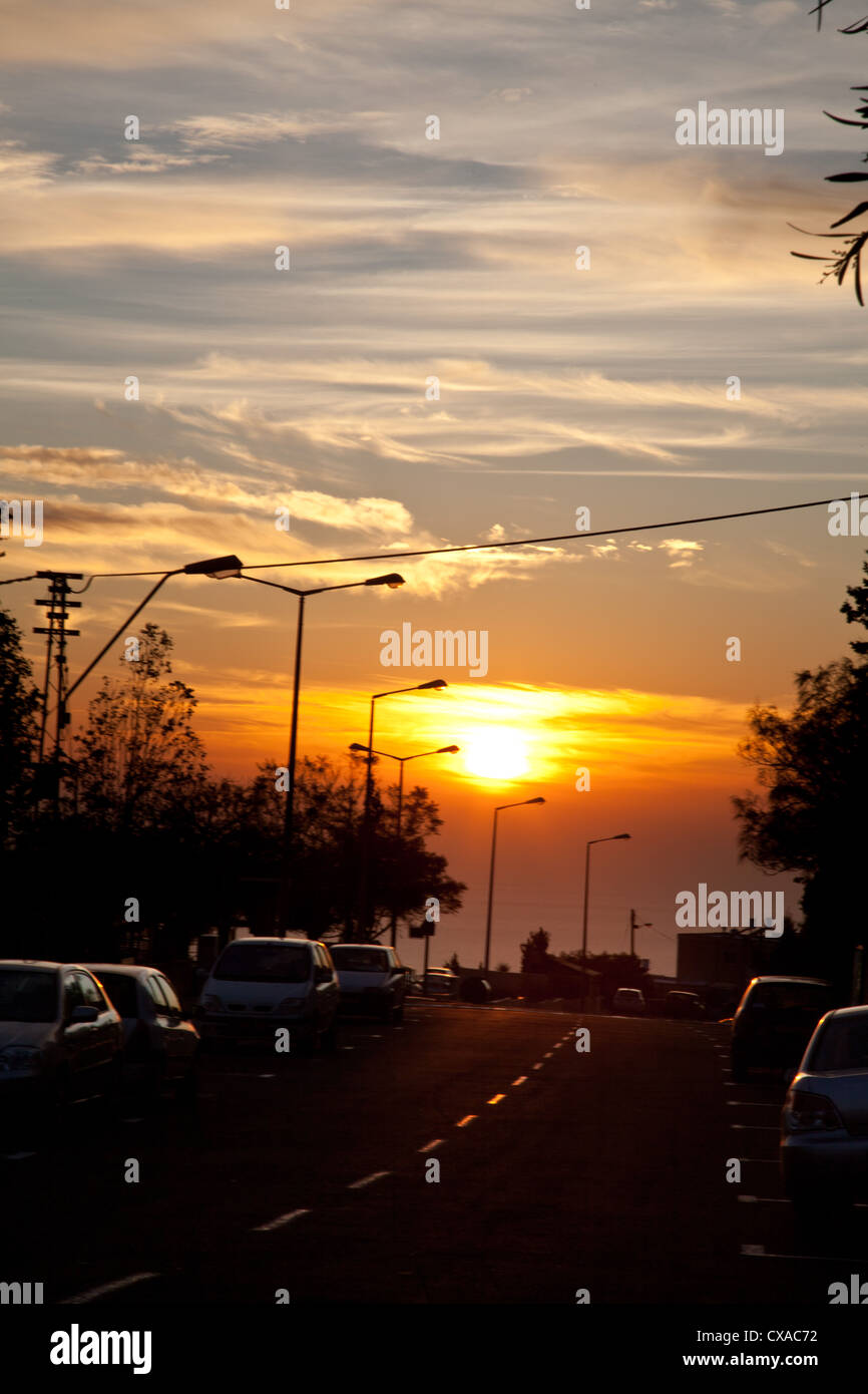 Straße im Sonnenuntergang in Haifa, Israel im Herbst, mit Autos geparkt Stockfoto