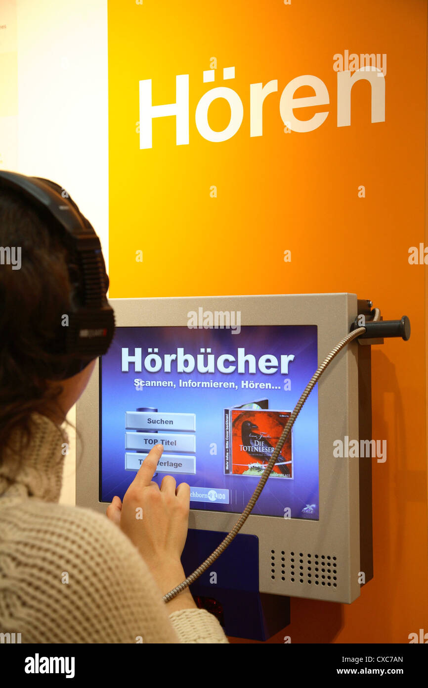 Leipziger Messe 2007: junge Frau testet Hörbuch Stockfoto