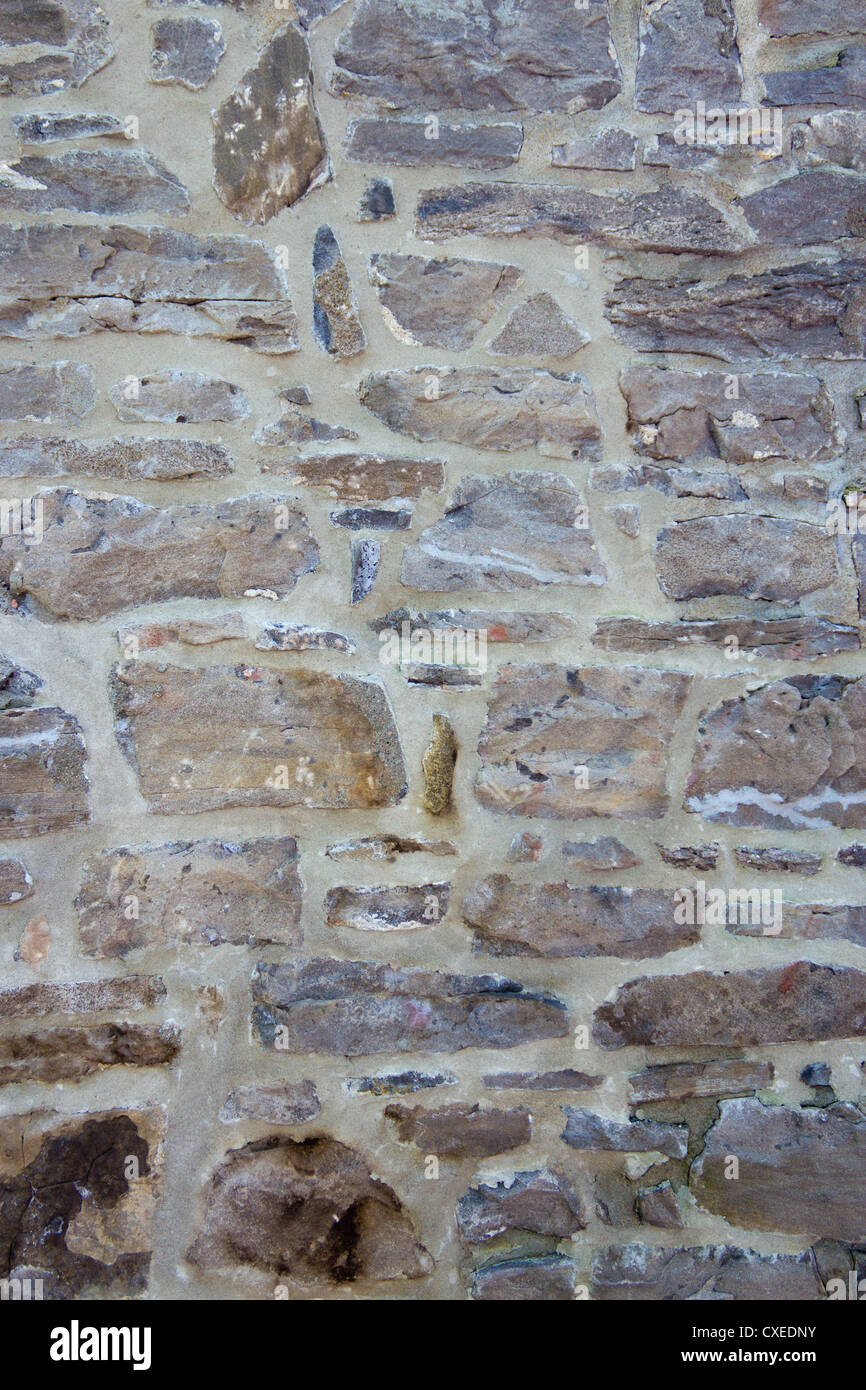Alte Mauer mit unregelmäßigen Muster aus Stein - Hintergrund. Stockfoto
