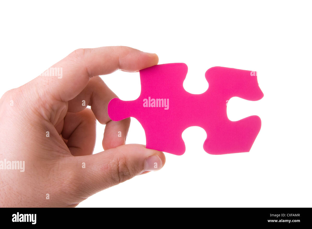Hand mit einem rosa Puzzle isoliert auf weiss Stockfoto
