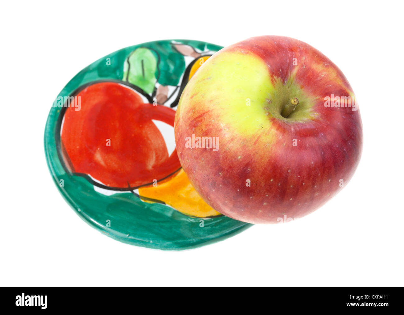 Ein Apfel auf eine bunte Runde Untersetzer mit Frucht-Motiv. Stockfoto