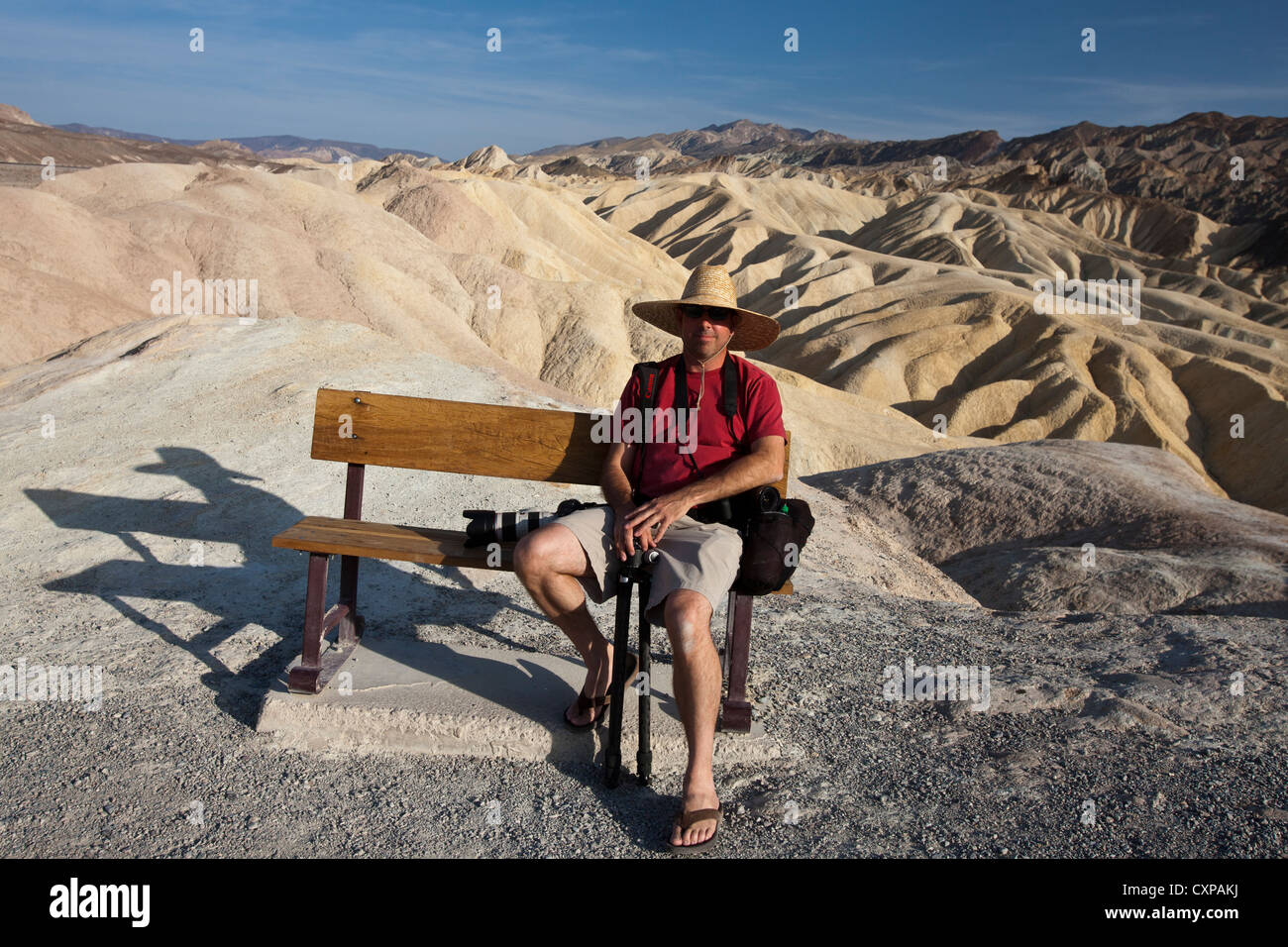 Männchen sitzt auf der Parkbank vor Badlands Zabriskie Point Death Valley Nationalpark Kalifornien USA Amerika Stockfoto