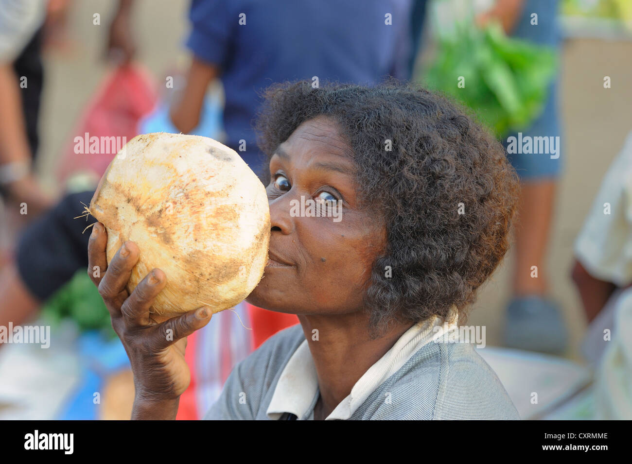 Papua-Frau ist als Ersatz für Wasser aus direkt aus der Kokosnuss, Gemüsemarkt in der Nähe von Kota Biak Kokosmilch trinken, Stockfoto