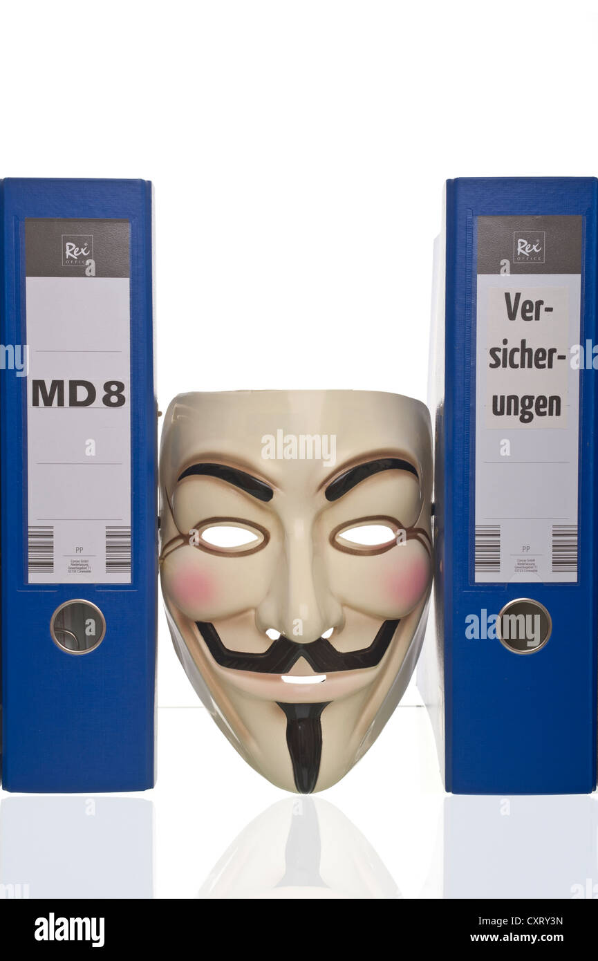 "Anonymous", Guy Fawkes oder "V for Vendetta" Maske, eingekeilt zwischen blauen ungekennzeichnete Ordner Stockfoto