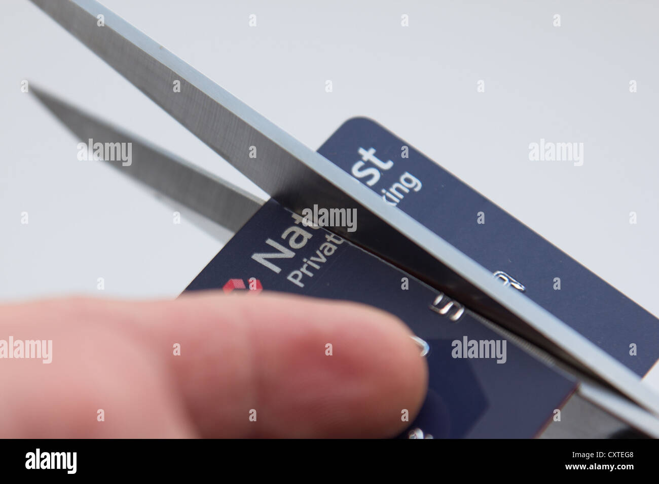 Ein Natwest zerschneiden private banking Konto Visa-Karte mit einer Schere Stockfoto