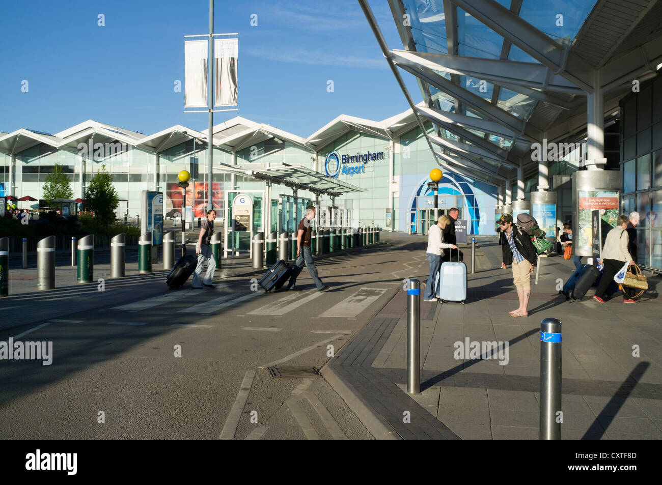 dh Airports Terminal Building BIRMINGHAM AIRPORT UK Passagiere, die mit ankommen Koffer vor dem Eingang zur Ankunft Stockfoto