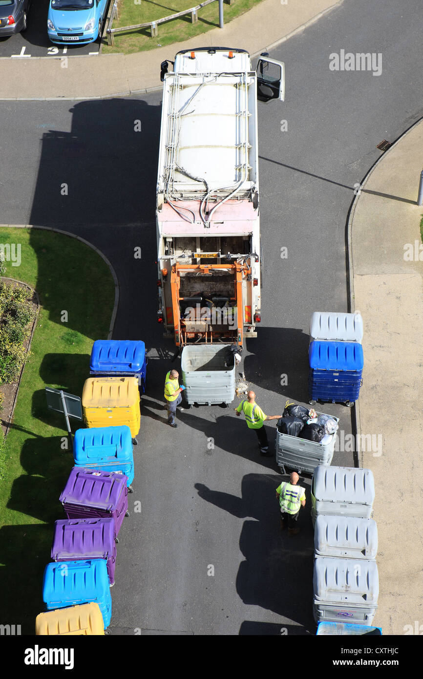 Kommunalbeschäftigten Entleerung der Behälter in eine Abfall-LKW Stockfoto