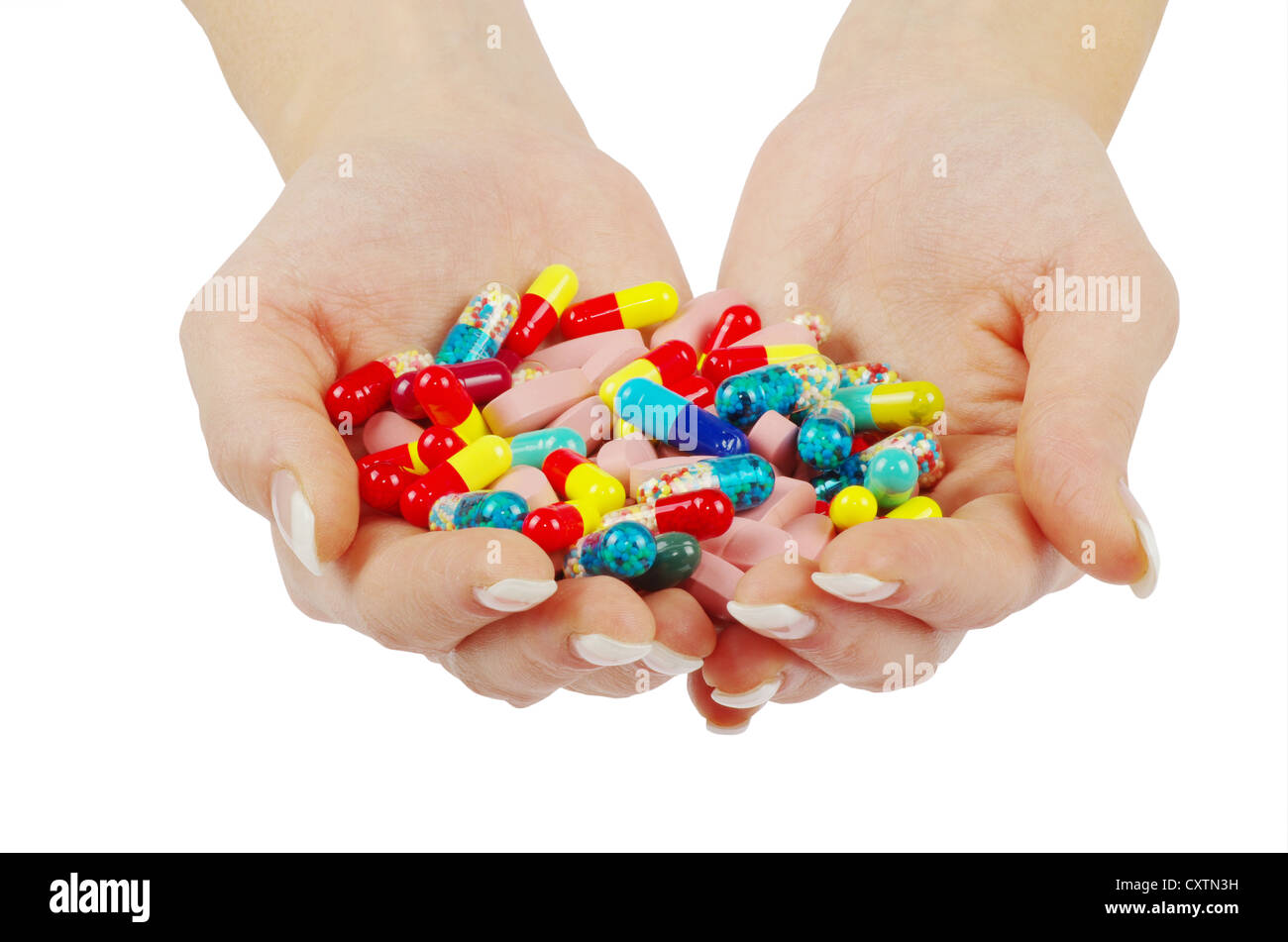 Händen hält Pille isoliert auf weiss Stockfoto