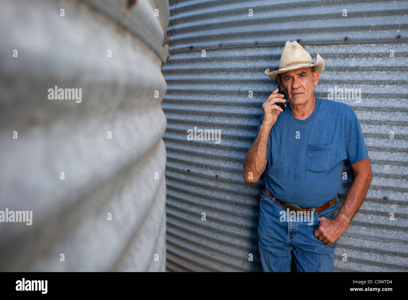 Landwirt reden über Handy von silos Stockfoto