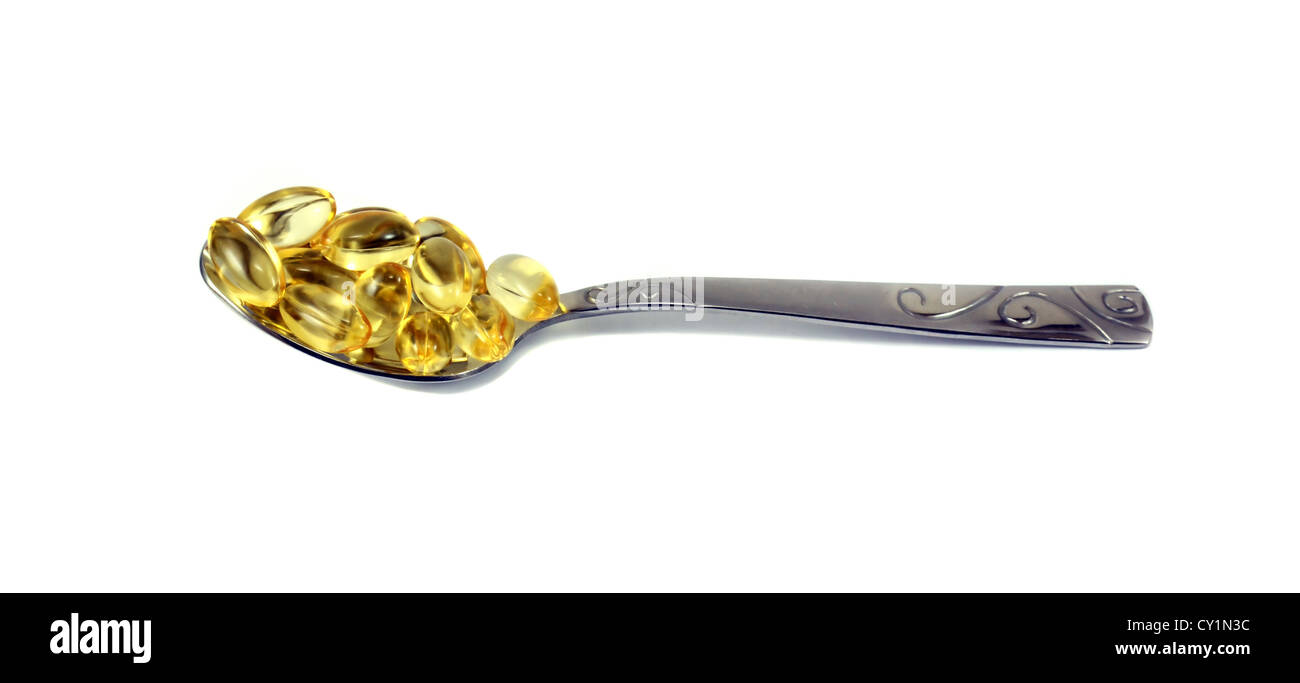 Vitamin E-Tabletten in einem Löffel gelegt Stockfoto