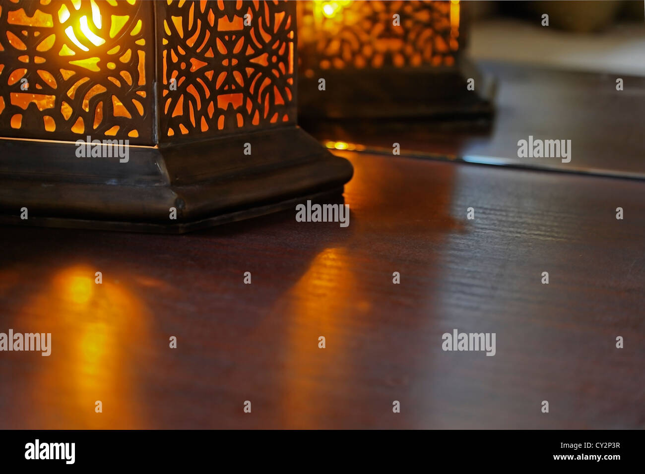 Amber farbigen Bul ibn einer orientalischen Ost Tabelle wirft Balken auf Tischfläche und Reflexionen im Spiegel Stockfoto