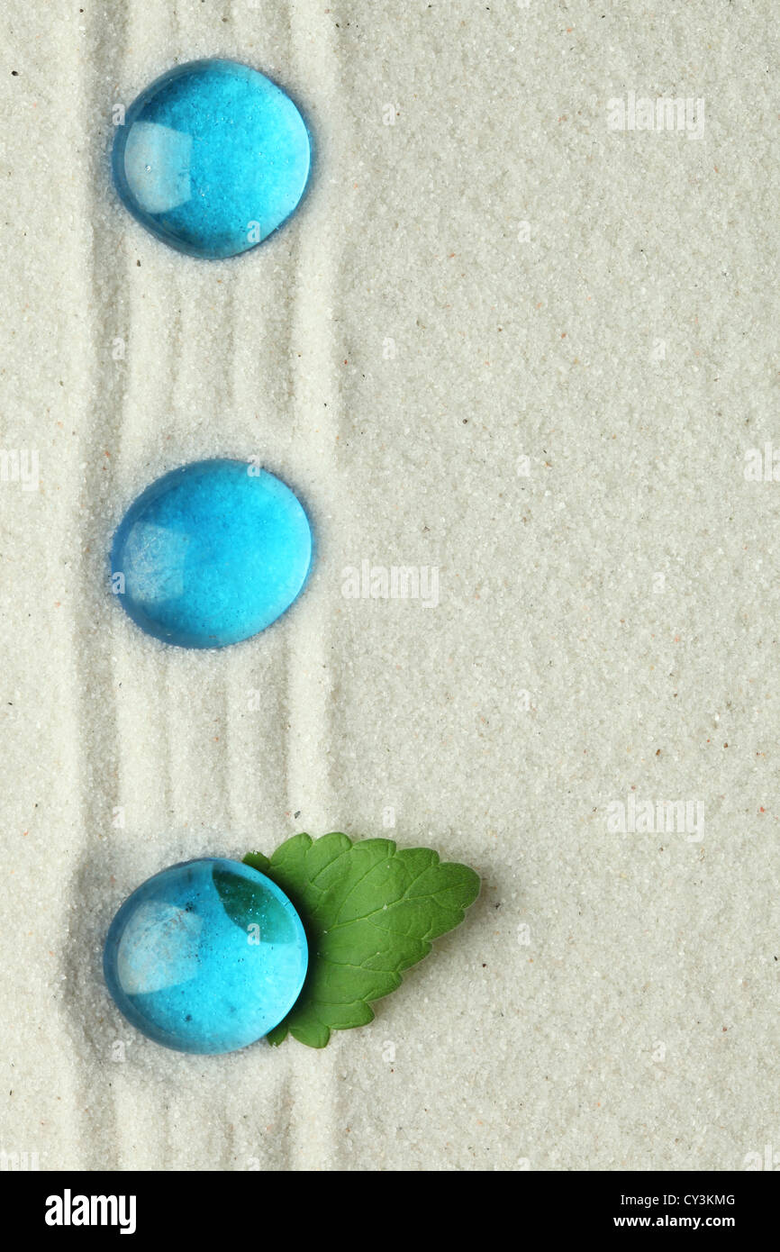 Blauen Glassteinen in sand Stockfoto