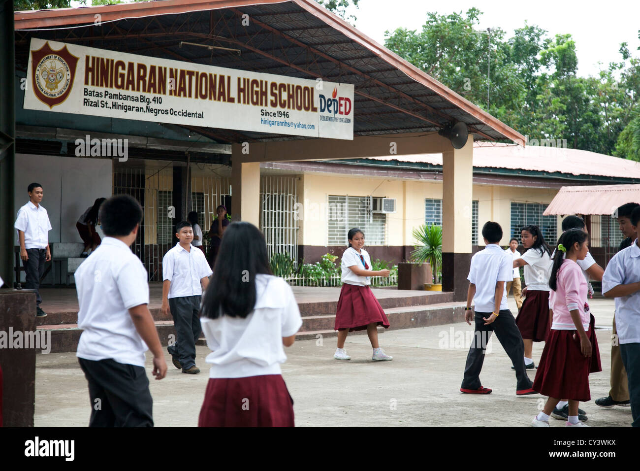 Hinigaran National High School. Es ist Pausenzeit, und Studenten ausgießen zu spielen und zu chatten. Stockfoto