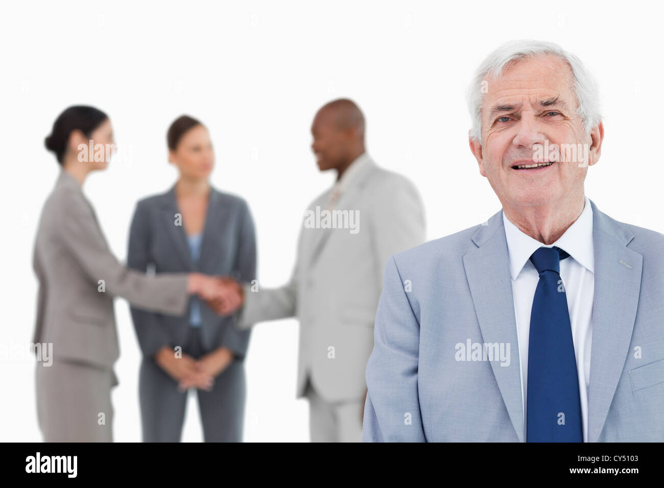Reife Verkäufer mit Handelspartnern hinter ihm Stockfoto