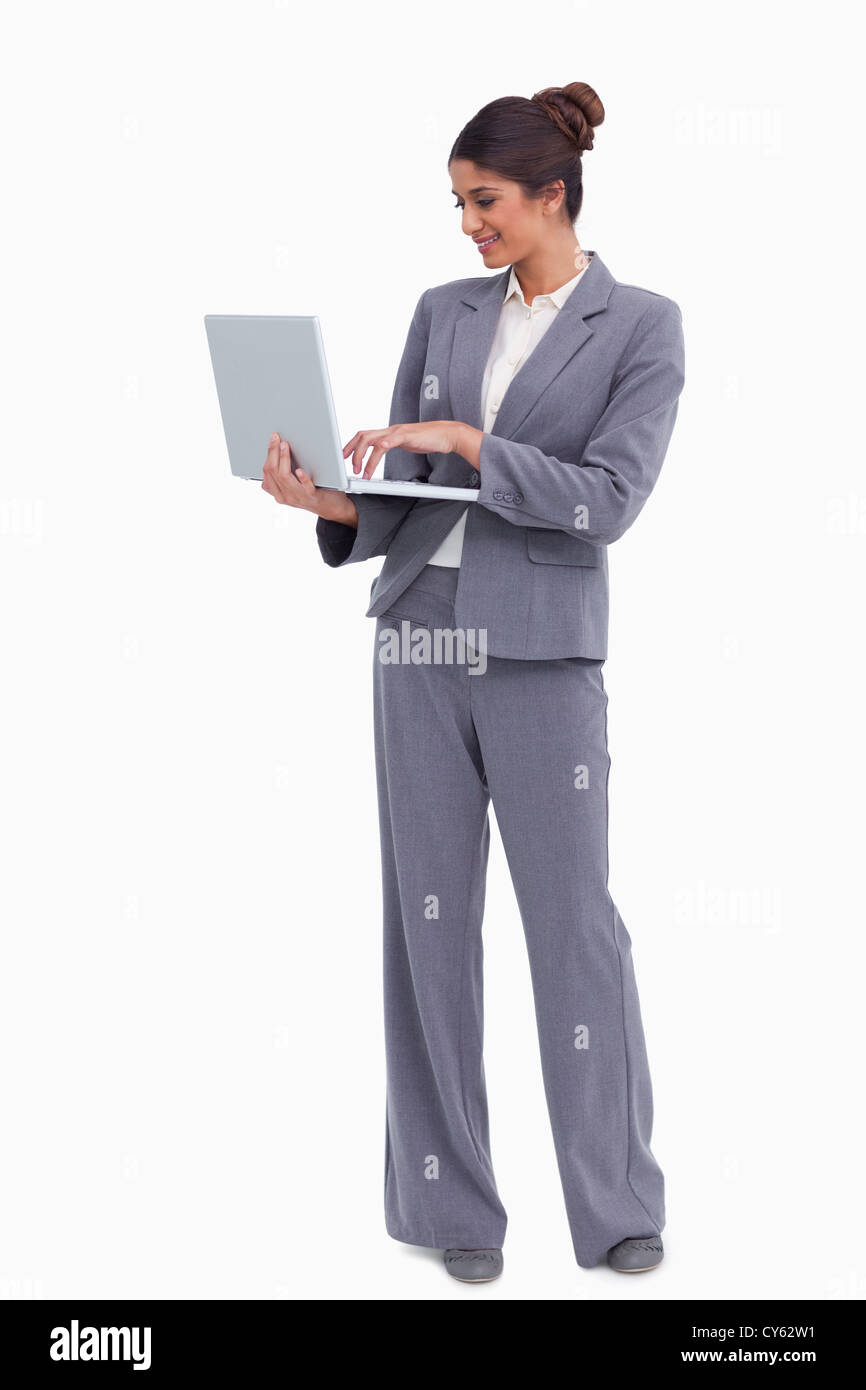 Lächelnde Unternehmerin auf ihrem Laptop arbeiten Stockfoto