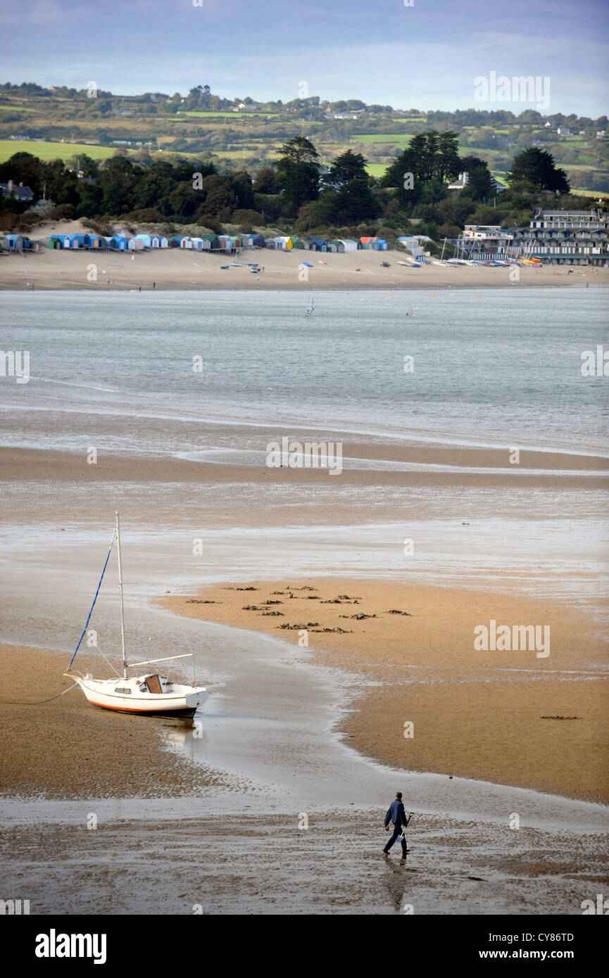 Ein Fischer mit einem Spaten nach Wattwürmern Graben überquert den Sand auf Borth Fawr oder Main Beach bei Abersoch auf Lleyn Peninsul Stockfoto