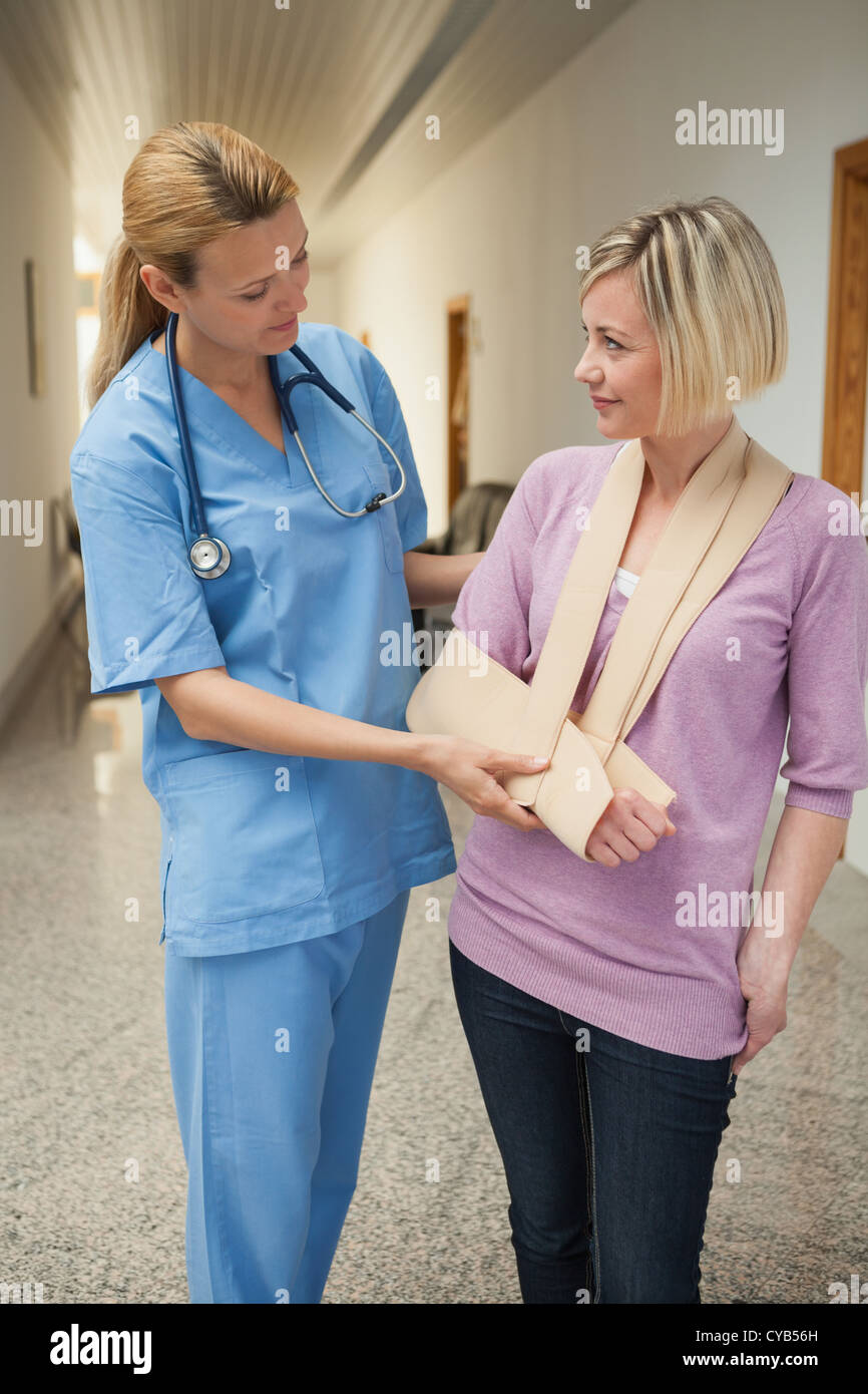 Krankenschwester, gebrochenen Arm des Patienten berühren Stockfoto
