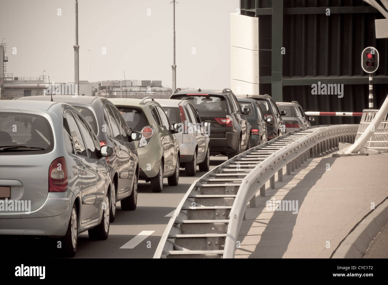 Warteschlange Autos gegen rote Ampel und offene Brücke. Getönten Bild Stockfoto