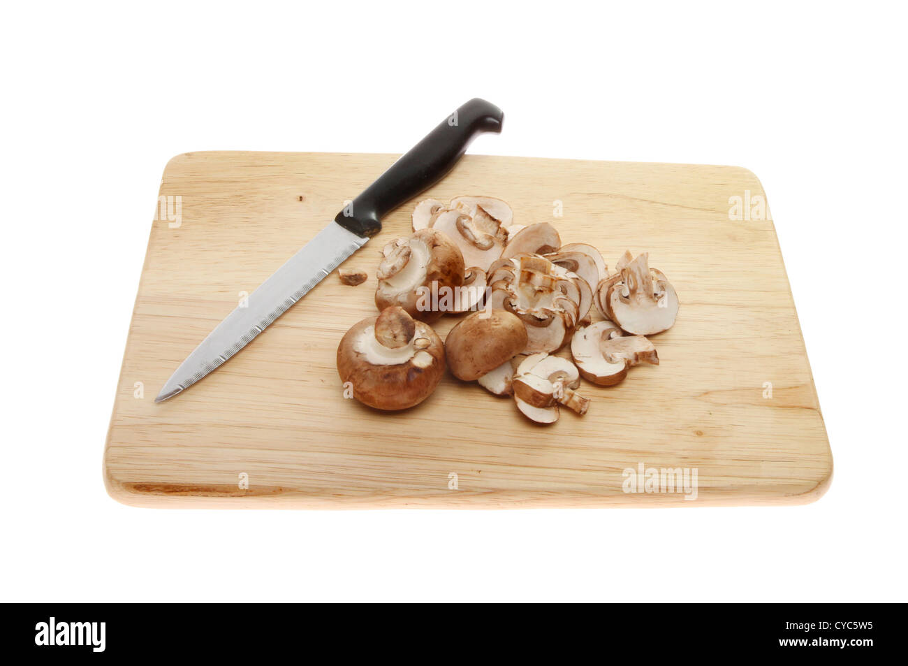Ganze und geschnittene Maronen Pilze auf einem Holzbrett mit einem Messer isoliert gegen weiß Stockfoto