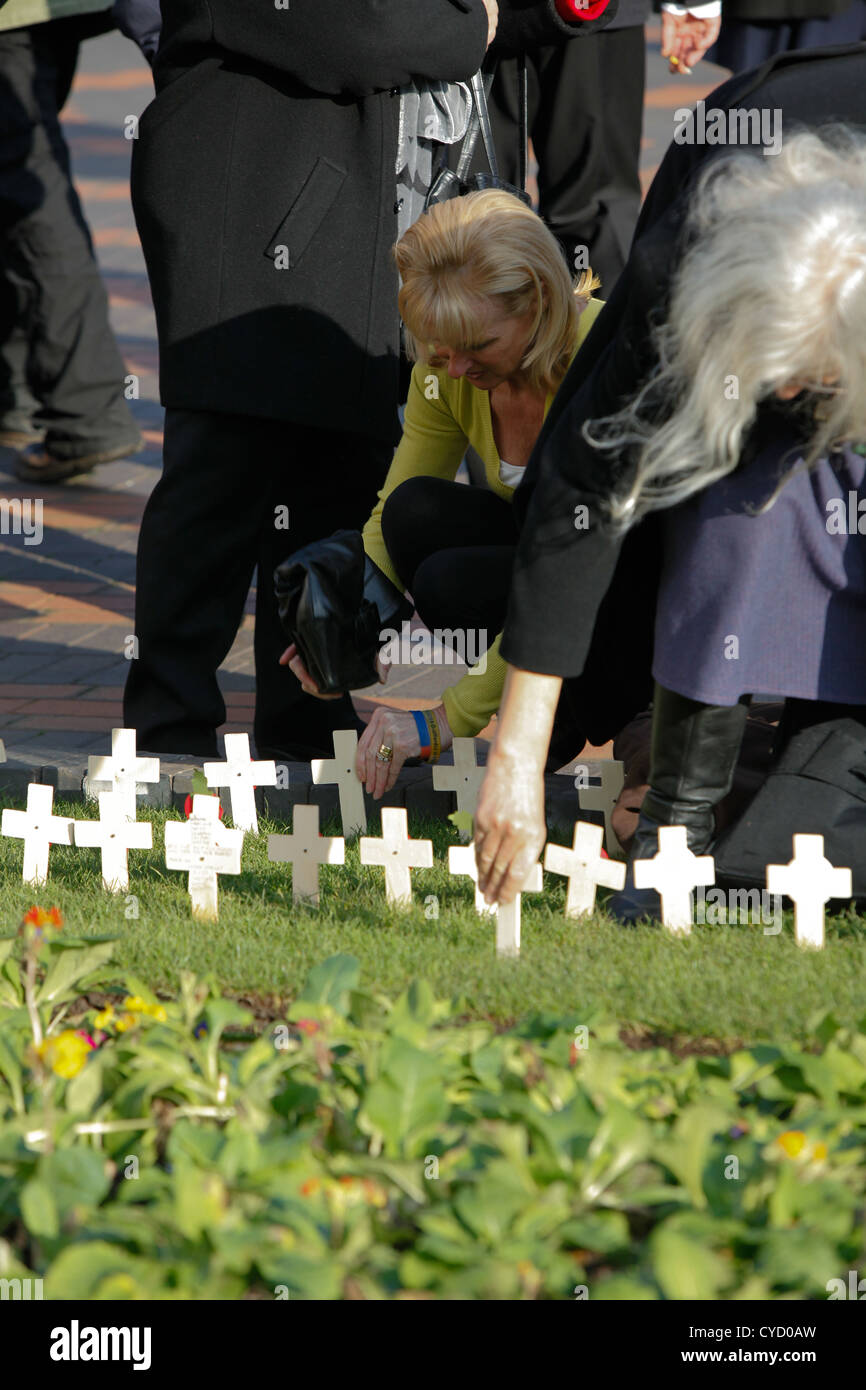 Eine Frau, indem ein Kreuz in den Boden rund um die Halle der Erinnerung Birmingham 2011. Stockfoto