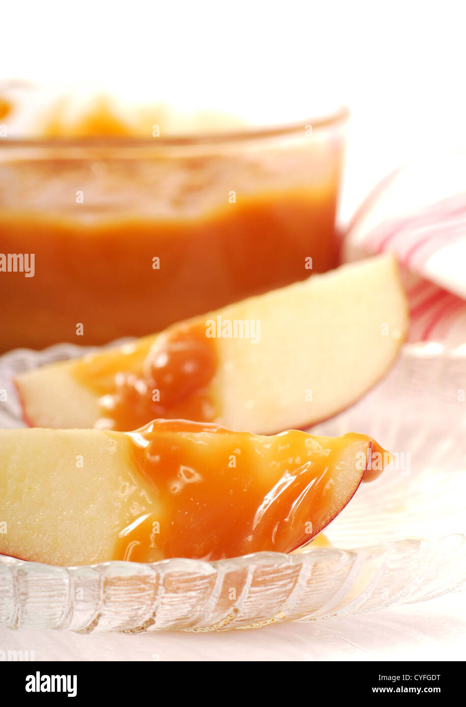 Frisch geschnittene Äpfel mit DIP-Sauce Karamell beträufelt, darauf Stockfoto