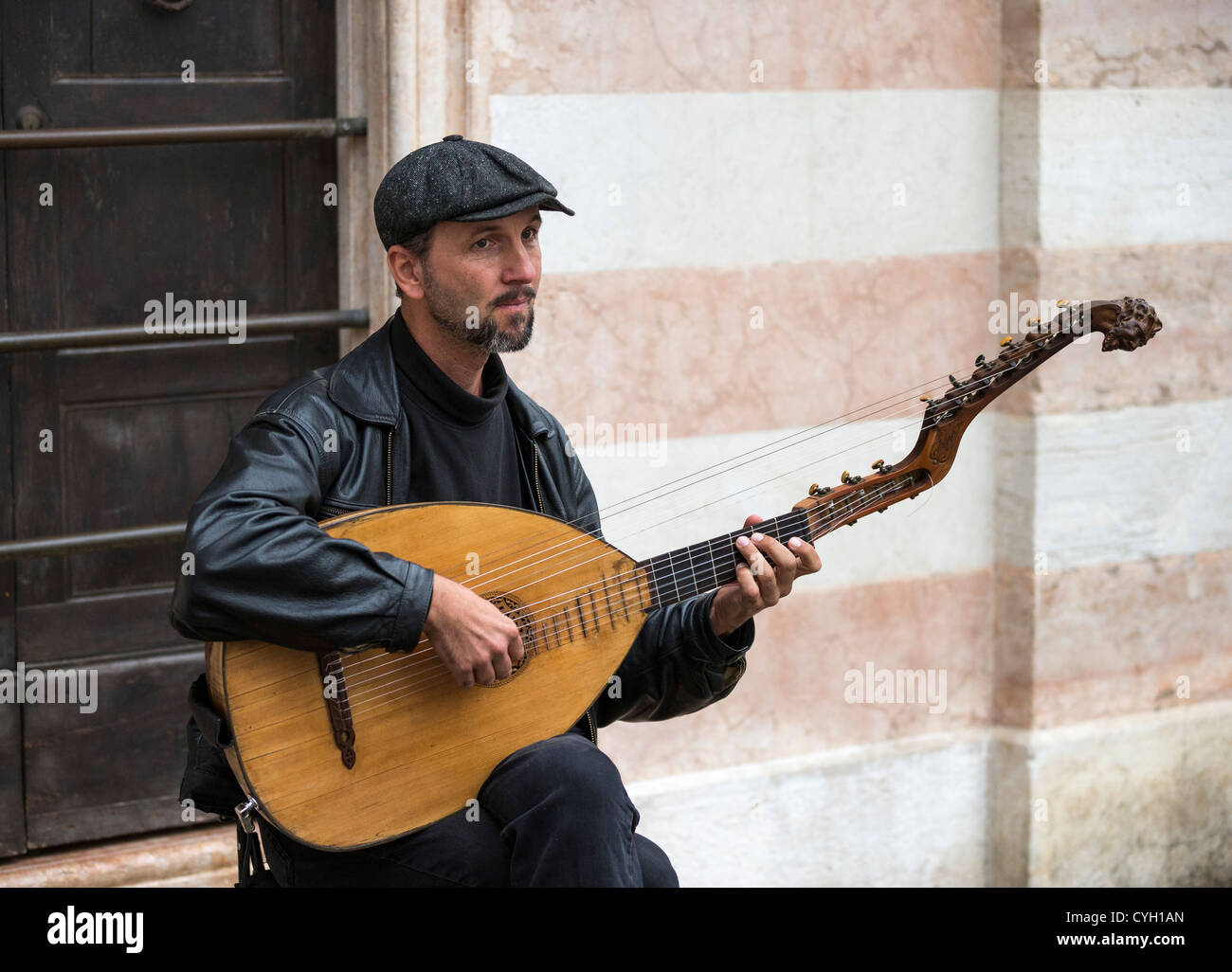 Ein Straßenmusikant ein lang-necked Laute mit einem zweiten Satz von Bundfreie Saiten Stockfoto