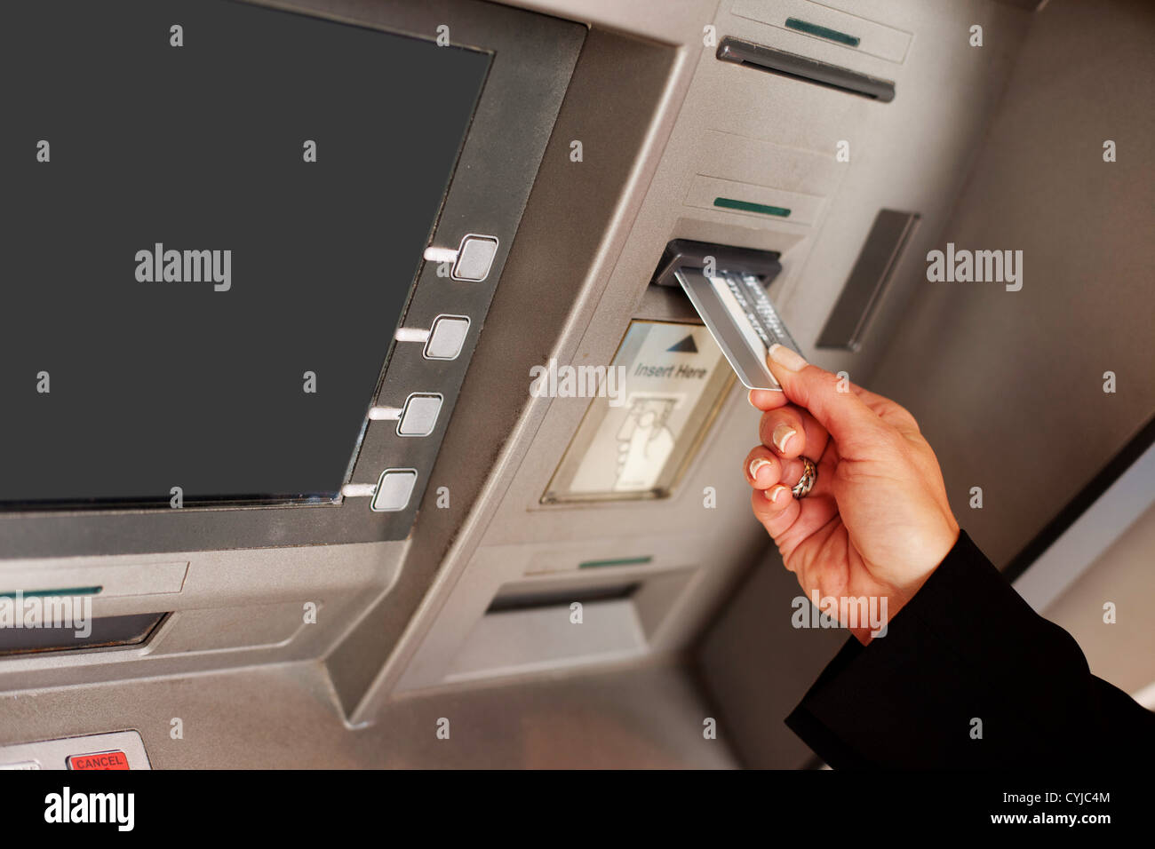 Blick auf eine weibliche Hand Einfügen einer Bankkarte in einen Geldautomaten, eine finanzielle Transaktion beginnen beschnitten Stockfoto