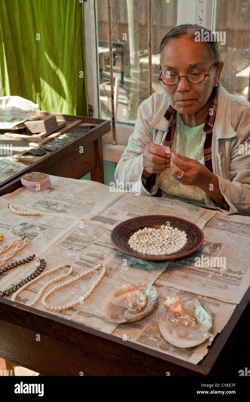 Myanmar, Burma. Burmesische Frau Einfädeln Perlen auf Halskette, Inle-See, Shan-Staat. Stockfoto