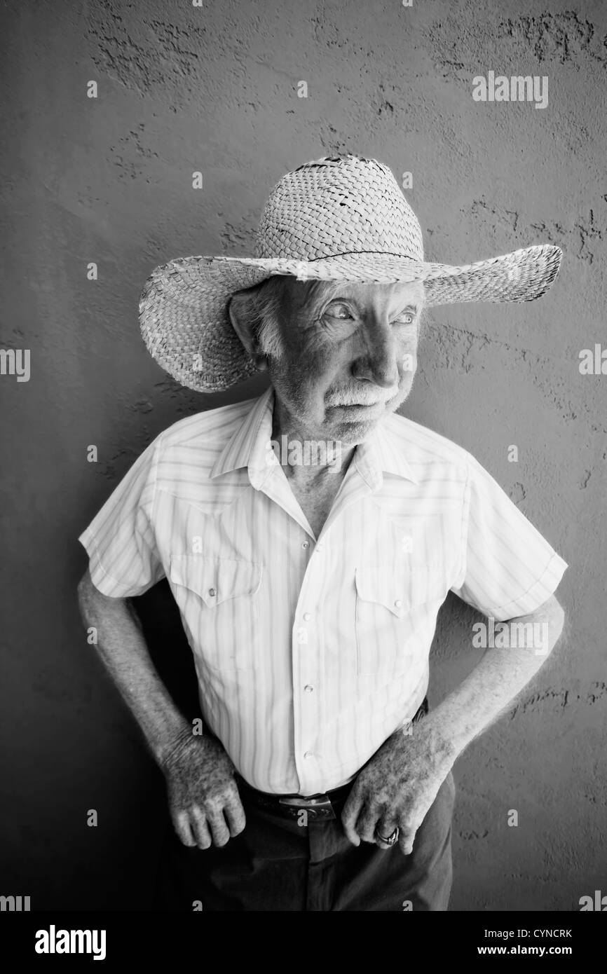 Senioren-Mann trägt einen Strohhut Cowboy sieht aus Stockfoto