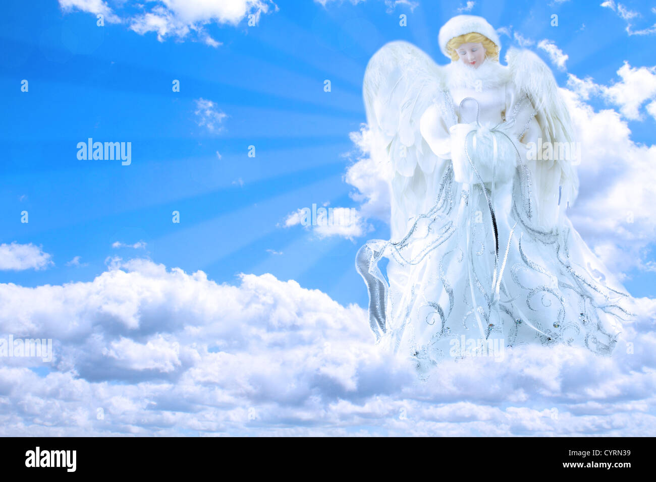 Schöne generische Engel im Himmel mit Strahlen von Licht, das hinter ihr beten. Stockfoto