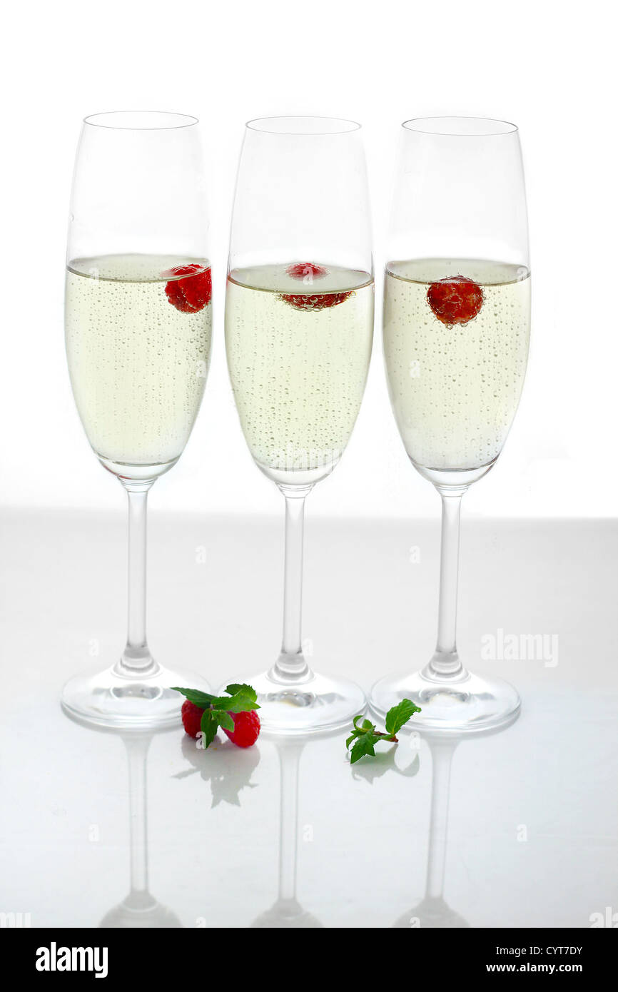 Champagner im Glas mit frischen roten Himbeeren Stockfoto