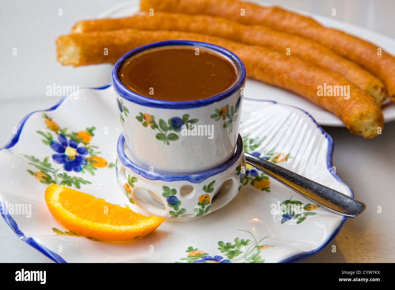 Heiße Schokolade serviert in einer verzierten Porzellantasse, mit spanischen porras Stockfoto