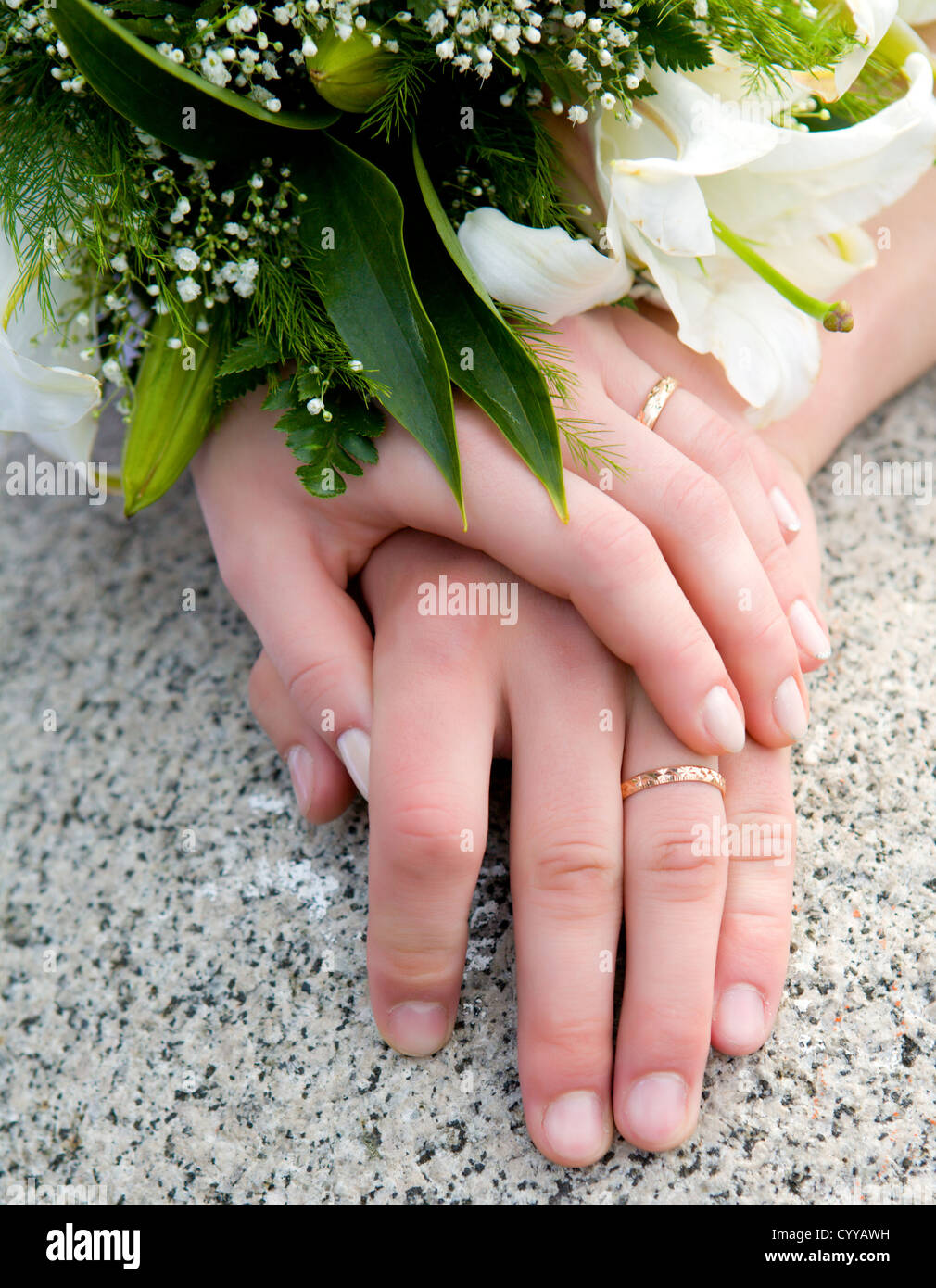 Händen der neuen verheiratet mit goldenen Ringen und Blumenstrauß Stockfoto
