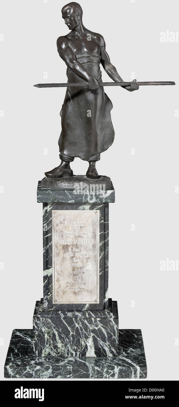Adolf Hitler - eine Präsentationsbronze zu seinem 50. Geburtstag 1939,Dunkle patinierte Skulptur eines Eisengießers,der Sockel signiert 'Iffland'.auf einem hohen, schwarzen Marmorsockel mit grüner Aderung.die Vorderseite mit silberner Widmungstafel 'dem Führer und Reichskanzler Adolf Hitler - dem ersten Arbeiter des Reichs zu seinem 50.Geburtstage übergeben' Und Reichskanzler Adolf Hitler - der erste Arbeiter des Reiches an seinem 50. Geburtstag überreicht'), auf der Rückseite mit einer weiteren silbernen Tafel 'in Dankbarkeit die Gefolgschaft der z.A.Chemnitz 20.April 1939',ne,Zusatz-Rechteklärung-nicht vorhanden Stockfoto