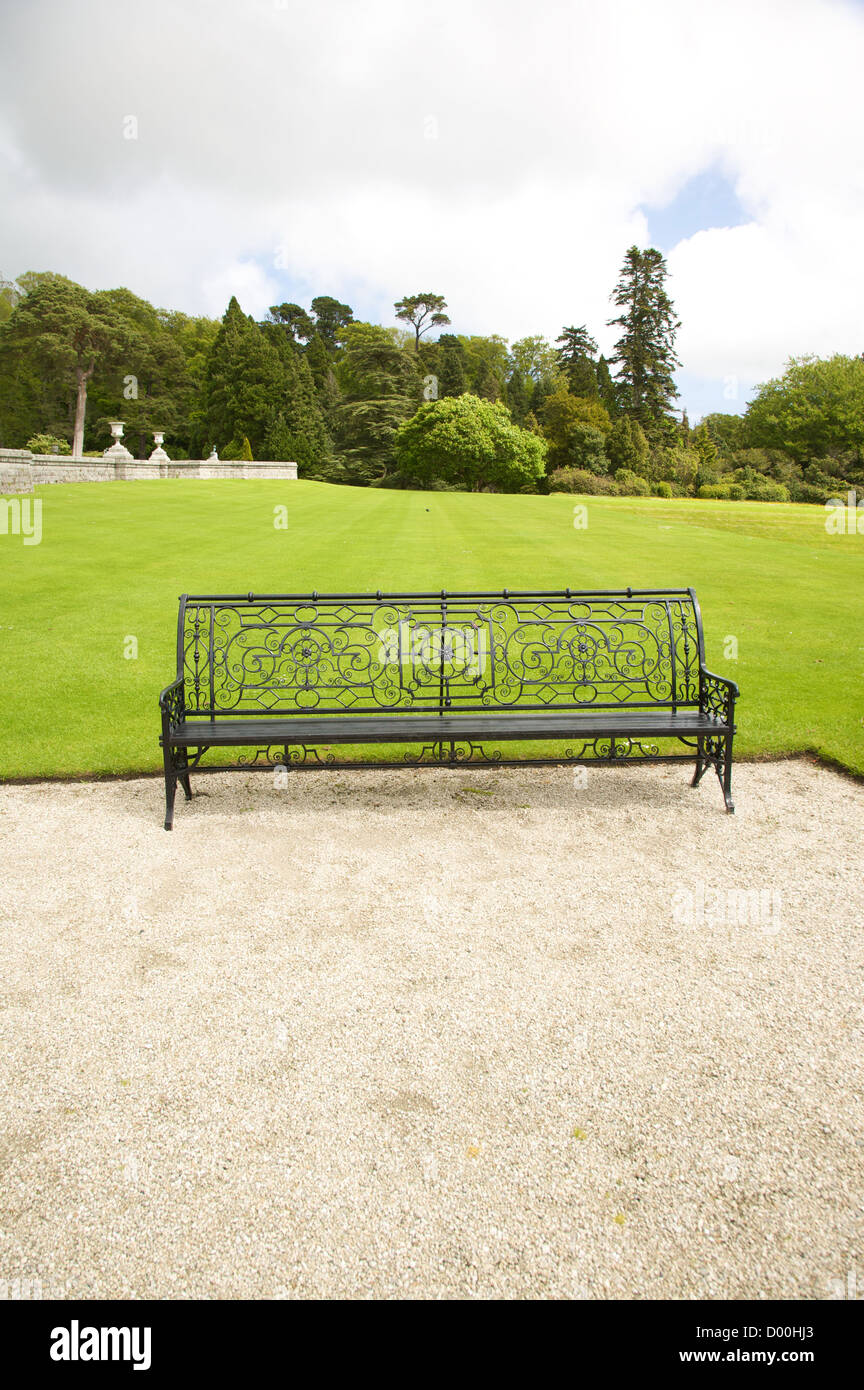 klassische Metallbank mit Schotter und Rasen Stockfoto