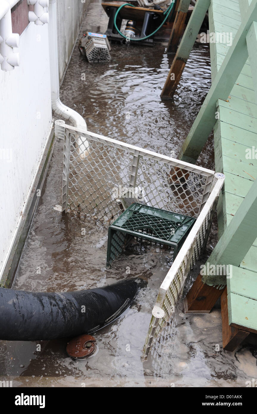Soldaten der 401. Quartermaster Detachment verwenden improvisierte Filter, um Wasser aus Breezy Point, New York, nach Hurrikan Sandy zu pumpen. Das Team arbeitet unter schwierigen Bedingungen an der Wiederherstellung der Versorgungsanlagen des Gebiets und leistet wichtige Unterstützung bei den Sanierungsbemühungen. Stockfoto