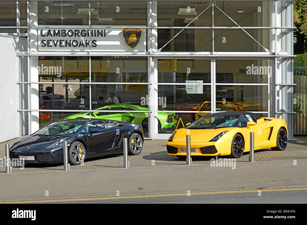 Lamborghini Auto Showroom und Straßenbahnvorplatz Geschäft mit italienischen Luxus-Sportwagen hinter abnehmbaren Pollern sonnigen Sevenoaks Kent England UK Stockfoto