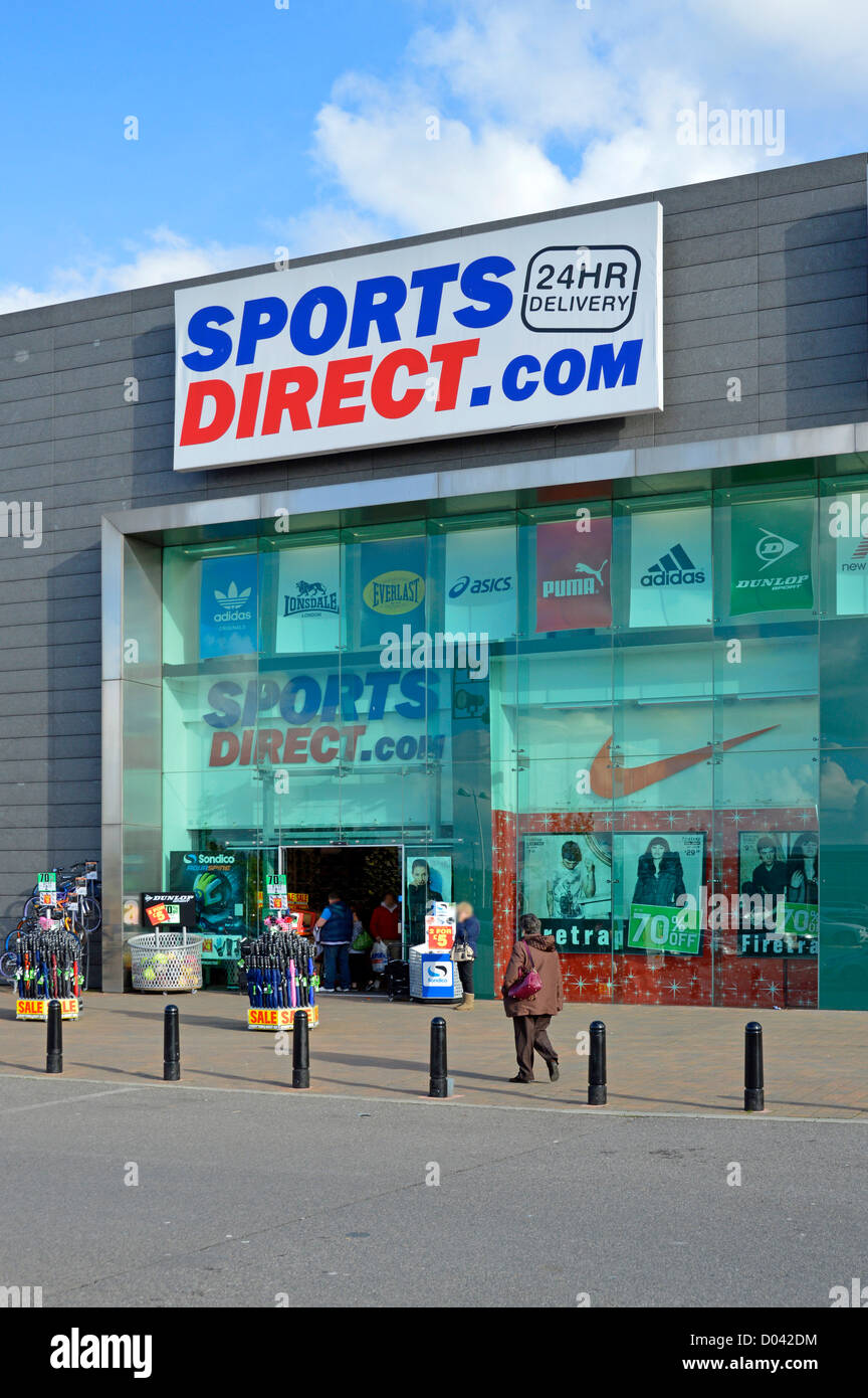 Frau-Shopper zu Fuß in Richtung Sports Direct Shop Stockfoto