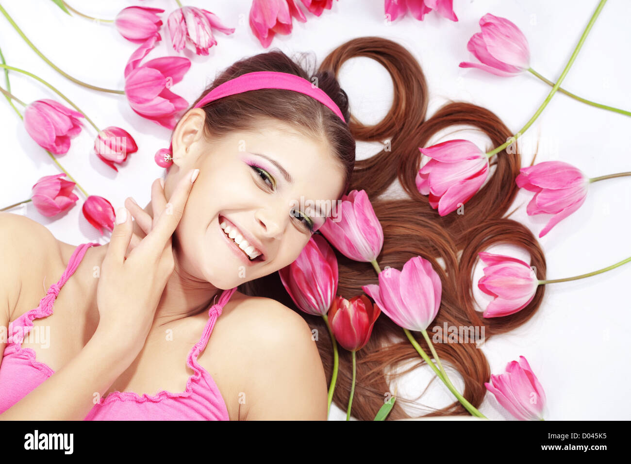 Porträt des Lügens schöne Wohlbefinden Mädchen mit spärlichen Tulpen Stockfoto