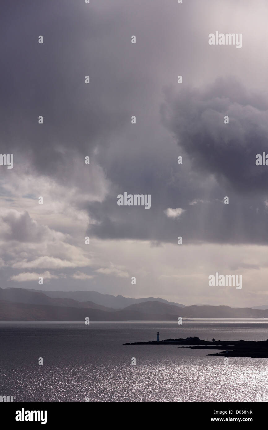 Dramatische Himmel und Sonne über Sound of Sleat mit Isle Ornsay Leuchtturm in Ferne, Schottland, Großbritannien Stockfoto