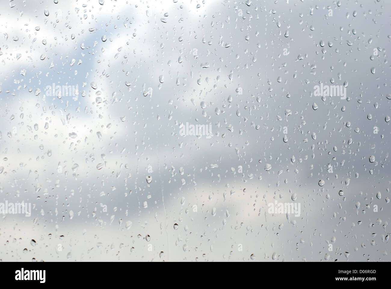 Regentropfen herabfließende auf Fenster-Glas-Zusammenfassung Stockfoto