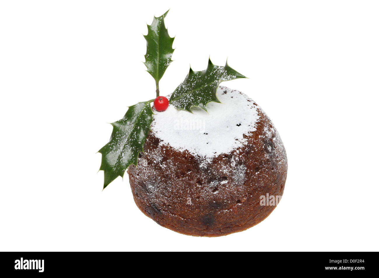 Christmas Pudding mit Puderzucker bestäubt und dekoriert mit Holly isoliert gegen weiß Stockfoto