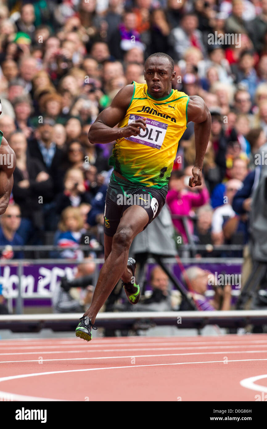 Usain Bolt (JAM) im Wettbewerb mit den Herren 100m 1. Runde bei den Olympischen Sommerspielen 2012 in London Stockfoto